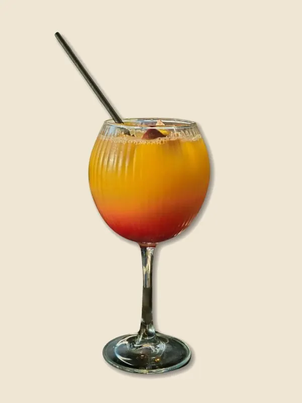 A Caribbean Sunset mocktail in a tall glass