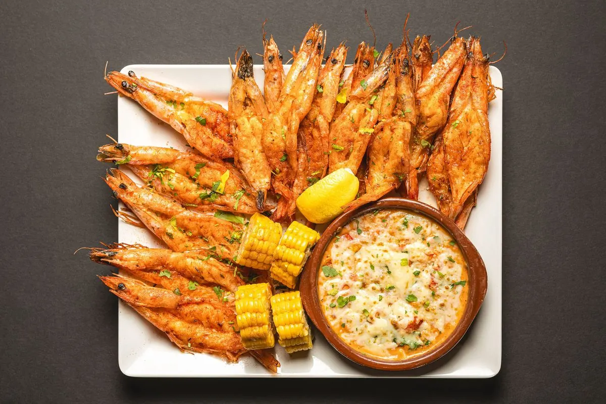 Grilled shrimp with corn on the cob and a creamy side
